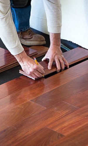 a545 A worker installing hardwood floor in an American upscale home.A worker installing hardwood floor in an American upscale home.